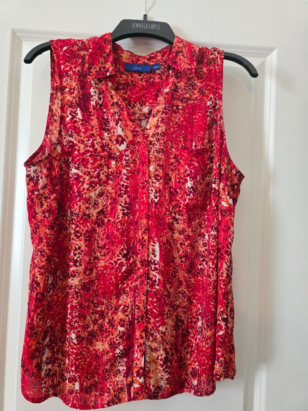 Sleeveless button down collared shirt